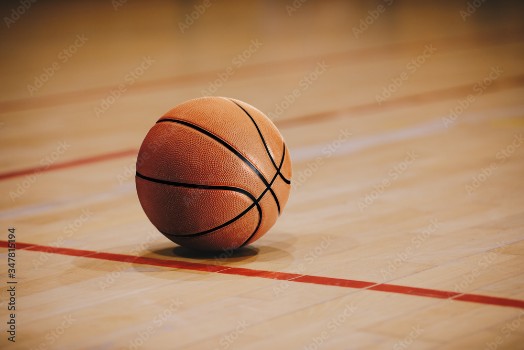 Bild på Classic Basketball on Wooden Court Floor Close Up with Blurred Arena in Background Orange Ball on a Hardwood Basketball Court